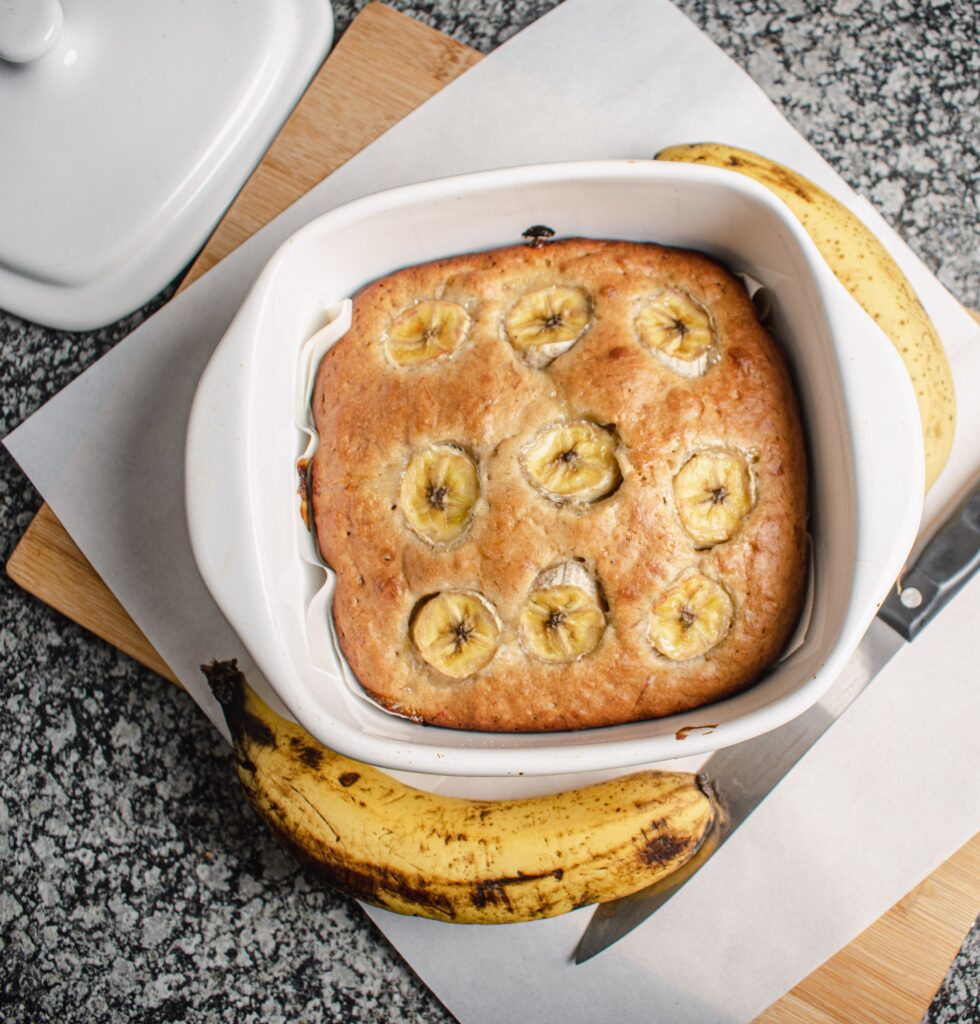 Delicious homemade banana bread in a white baking dish, perfect for a healthy snack.